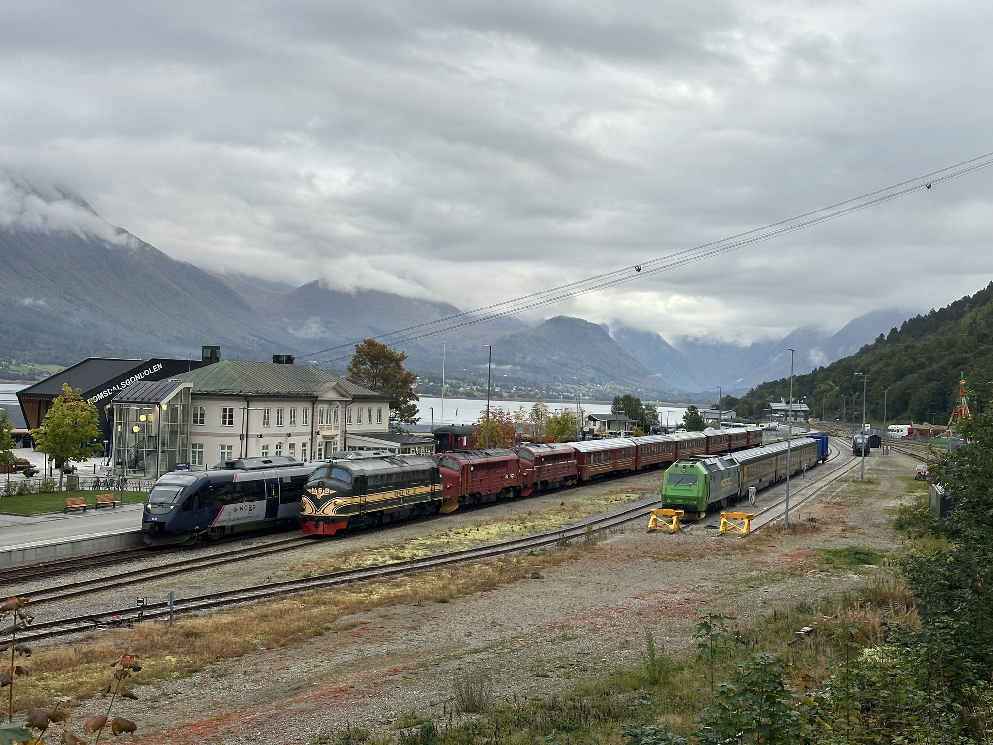 Åndalsnes stasjon med SJs ordinære tog tv, jubileumstoget og Golden Trains turisttog til høyre.